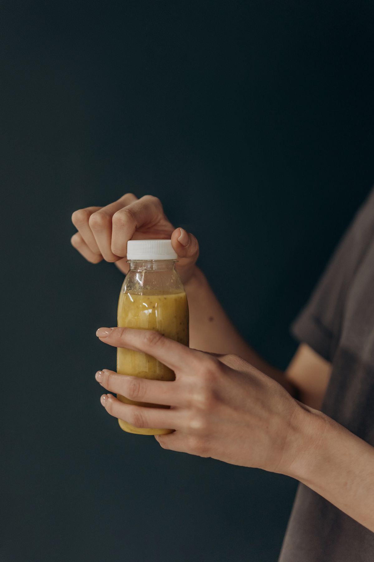 Person opening a wellness drink